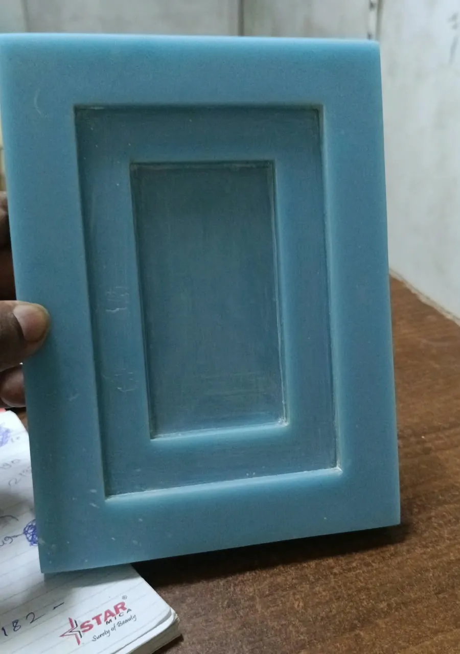 A blue moulded sample showing the stepped frame and recessed panel